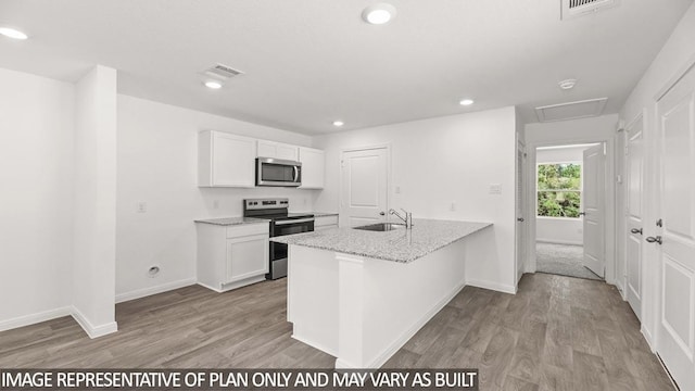 kitchen featuring white cabinets, sink, light stone countertops, appliances with stainless steel finishes, and light hardwood / wood-style floors