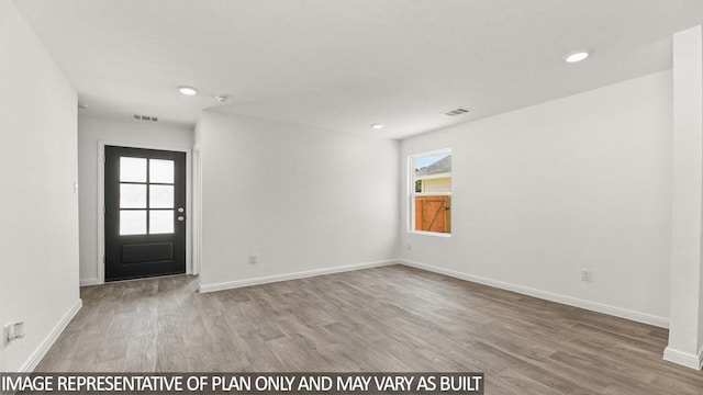 11983 Midas Ln, Willis, TX 77378 - entryway with wood finished floors and recessed lighting