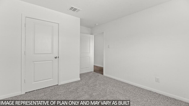 unfurnished bedroom with light colored carpet