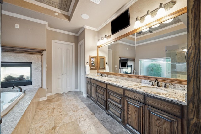 bathroom with vanity, a tray ceiling, separate shower and tub, and crown molding