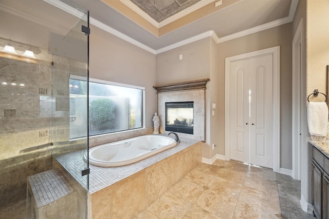 bathroom with crown molding, vanity, and shower with separate bathtub