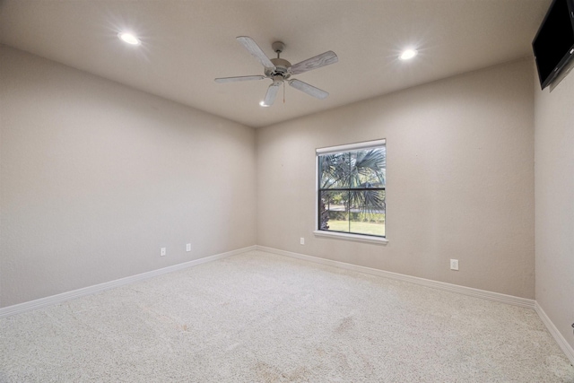 carpeted spare room featuring ceiling fan