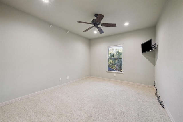 carpeted spare room with ceiling fan