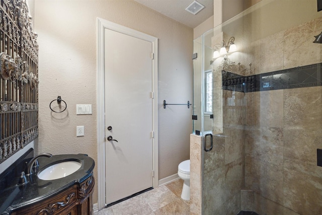 bathroom with toilet, vanity, and walk in shower