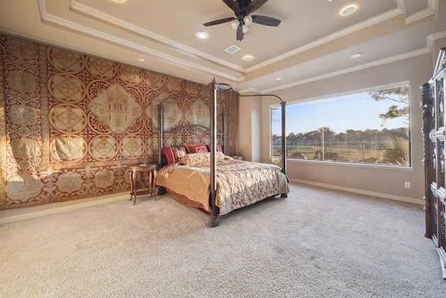 carpeted bedroom with a raised ceiling, ceiling fan, and ornamental molding