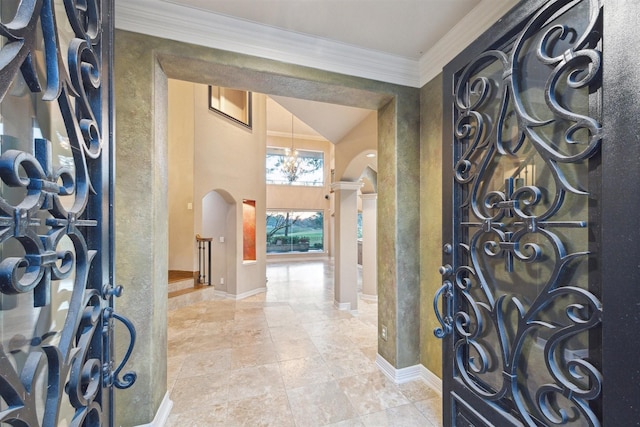 foyer with a notable chandelier and ornamental molding