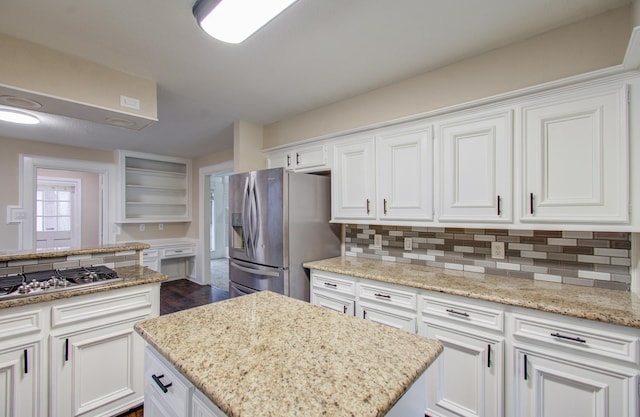 kitchen with light stone countertops, white cabinetry, and stainless steel appliances