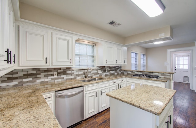 kitchen featuring white cabinets, dark hardwood / wood-style flooring, stainless steel appliances, and a kitchen island