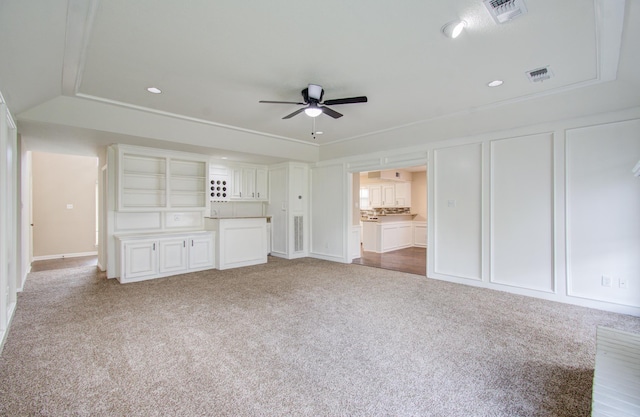 unfurnished living room with ceiling fan and carpet floors