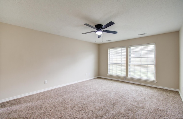 empty room featuring carpet, a textured ceiling, and ceiling fan