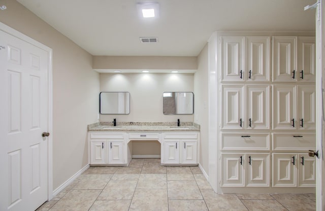 bathroom with tile patterned floors and vanity