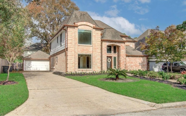 view of front of property featuring a garage and a front lawn