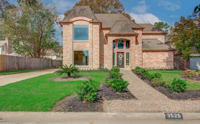 french country inspired facade with a front yard