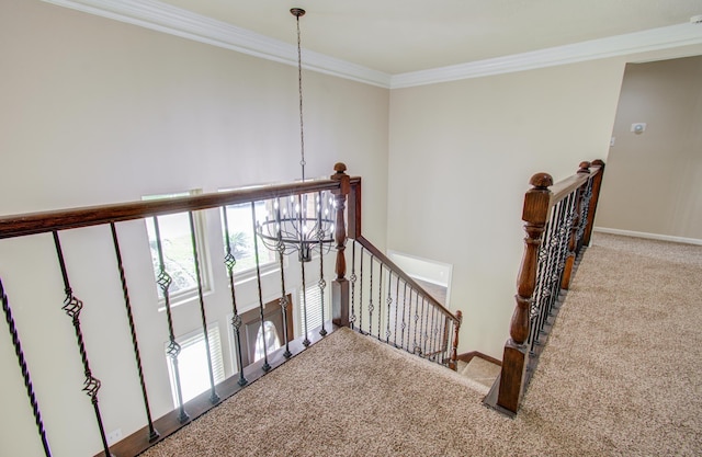 stairway featuring carpet, crown molding, and a notable chandelier