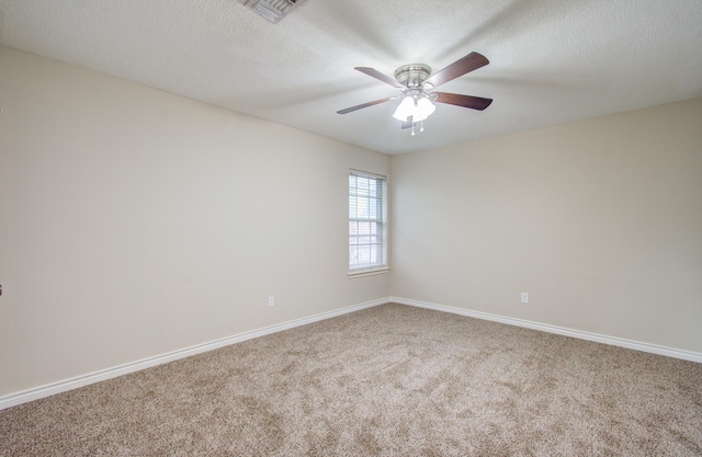 spare room with carpet flooring, ceiling fan, and a textured ceiling