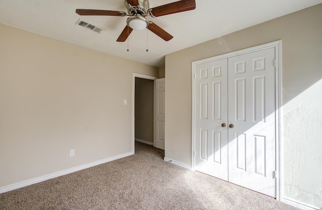 unfurnished bedroom with light carpet, a closet, and ceiling fan