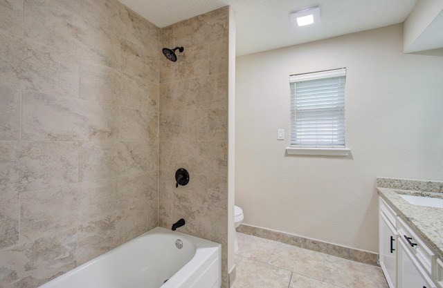 full bathroom featuring tile patterned flooring, vanity, toilet, and tiled shower / bath combo