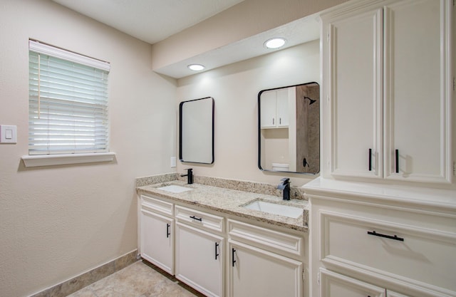 bathroom featuring tile patterned flooring and vanity