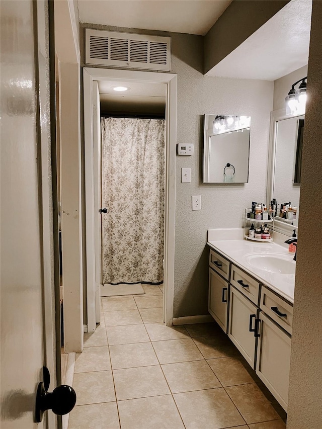 bathroom featuring tile patterned flooring and vanity