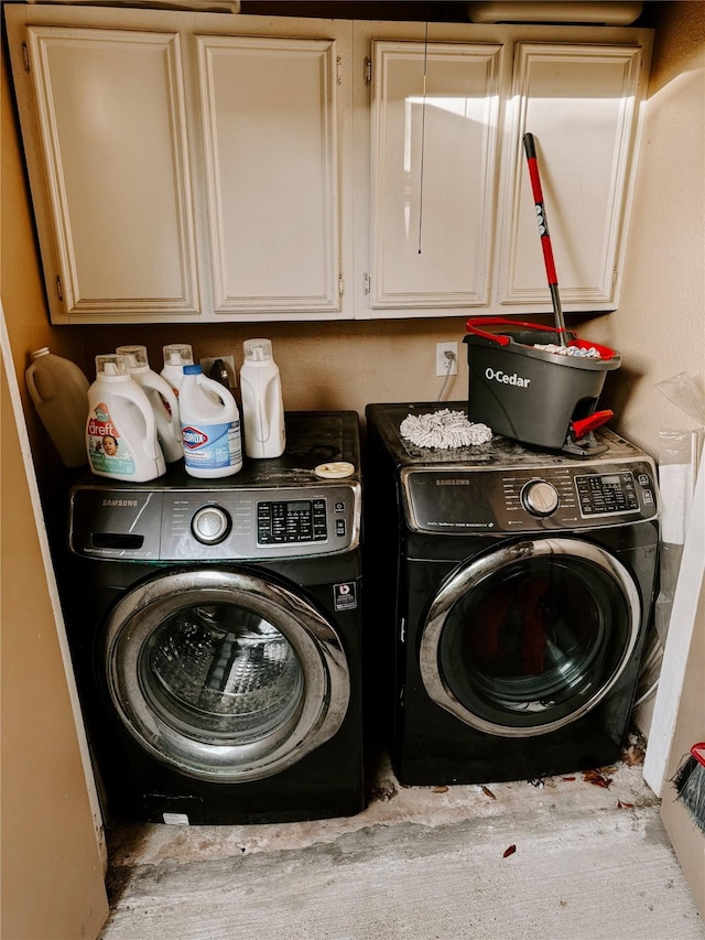 laundry room featuring cabinets and separate washer and dryer