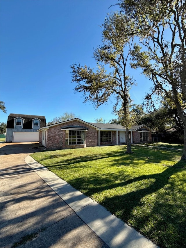 ranch-style home featuring a front yard