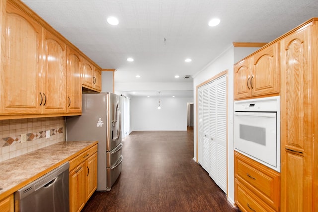 kitchen featuring backsplash, dark hardwood / wood-style floors, stainless steel appliances, and crown molding