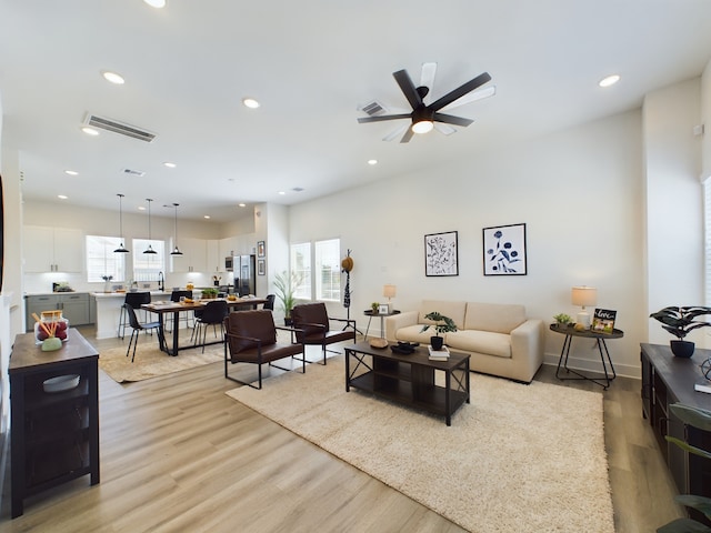 8321 Springwood Creek Ln, Houston, TX 77055 - living area with light wood finished floors, ceiling fan, and recessed lighting