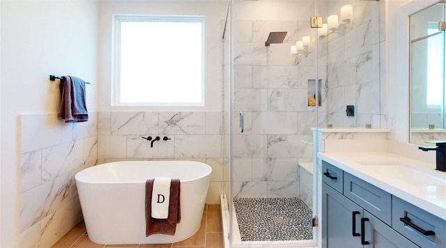 8321 Springwood Creek Ln, Houston, TX 77055 - full bathroom featuring tile walls, a shower stall, a freestanding bath, vanity, and tile patterned floors