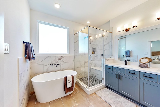 8321 Springwood Creek Ln, Houston, TX 77055 - full bath with a stall shower, vanity, tile patterned flooring, a freestanding tub, and tile walls