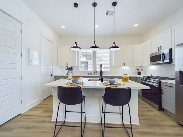 8321 Springwood Creek Ln, Houston, TX 77055 - kitchen featuring appliances with stainless steel finishes, a sink, light countertops, tasteful backsplash, and recessed lighting