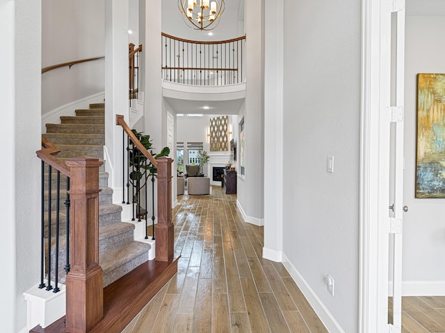 foyer entrance with a chandelier and wood-type flooring