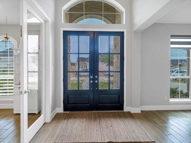 foyer entrance featuring wood-type flooring and french doors