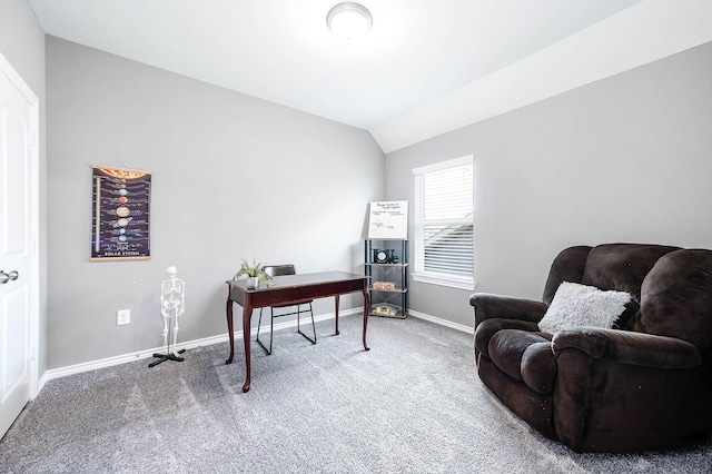 carpeted home office featuring vaulted ceiling