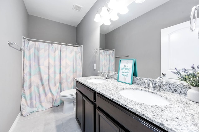 bathroom featuring tile patterned flooring, vanity, and toilet