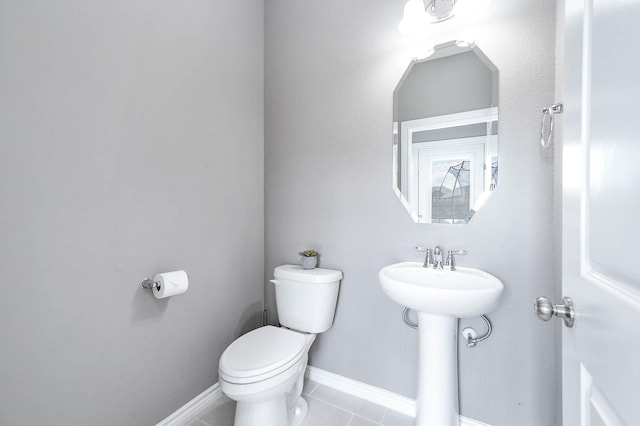 bathroom with toilet and tile patterned floors