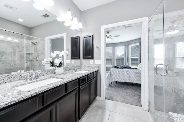 bathroom with tile patterned flooring, vanity, ceiling fan, and a shower with shower door