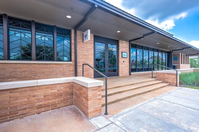 doorway to property with a porch and french doors