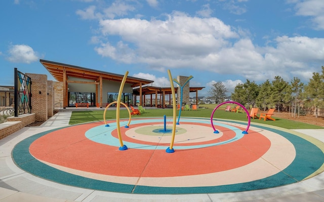 view of home's community with a playground and a lawn