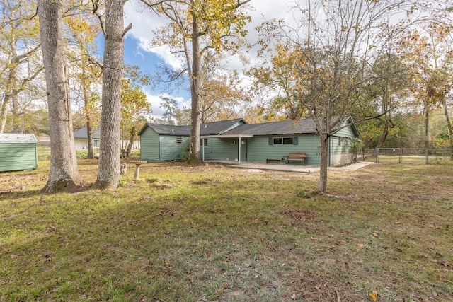 back of house featuring a patio area and a yard