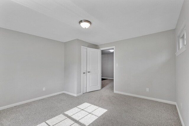 unfurnished bedroom featuring light carpet