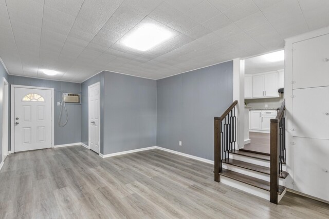 entryway featuring light hardwood / wood-style flooring and a wall mounted AC