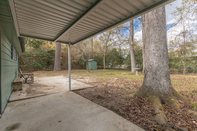 view of yard featuring a shed and a patio area