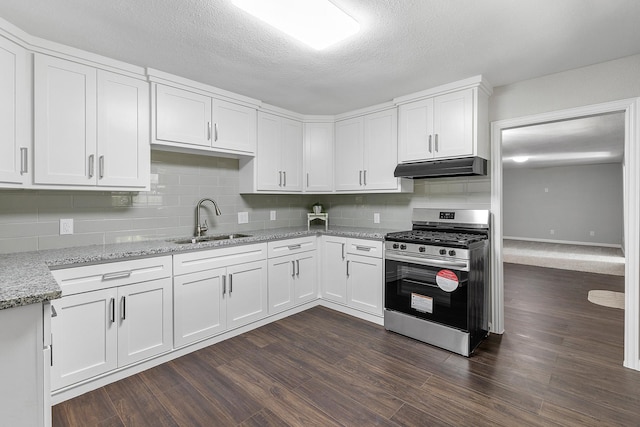 kitchen with white cabinets, sink, stainless steel gas stove, light stone countertops, and dark hardwood / wood-style flooring