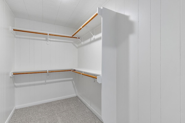 walk in closet featuring light colored carpet