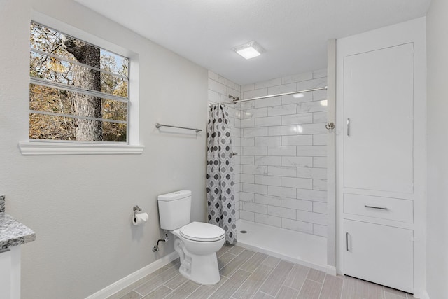 bathroom with a shower with curtain and toilet