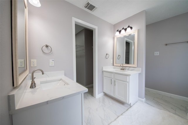 bathroom with a textured ceiling and vanity