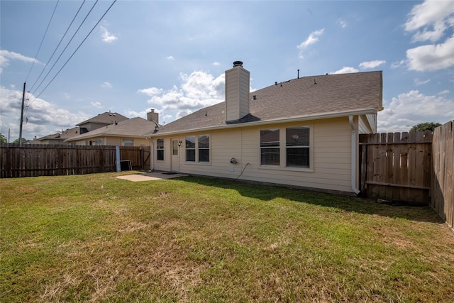 back of house with a lawn