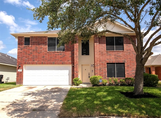 view of property with a front yard and a garage