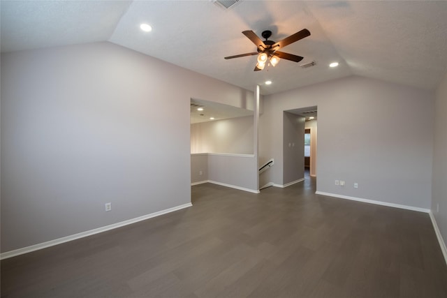 unfurnished room with vaulted ceiling, ceiling fan, a textured ceiling, and dark hardwood / wood-style floors