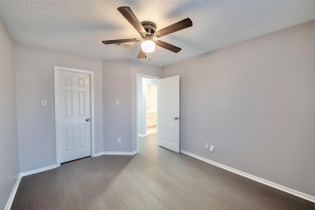 unfurnished bedroom with ceiling fan, a textured ceiling, and hardwood / wood-style flooring